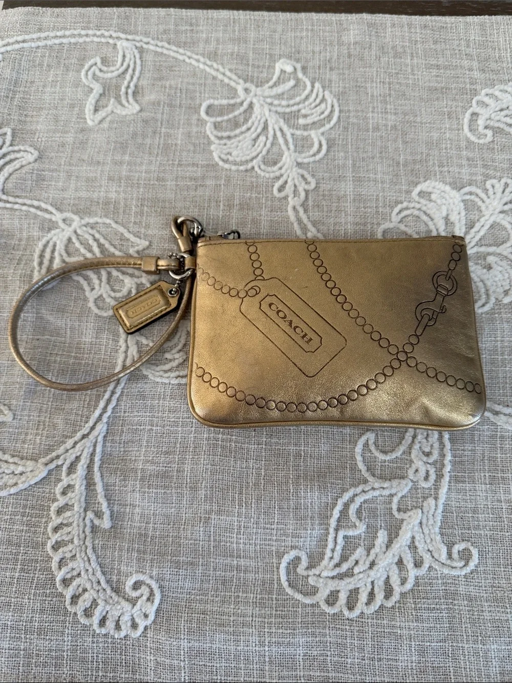 Coach Metallic Gold Wristlet with Embossed Chain Motif